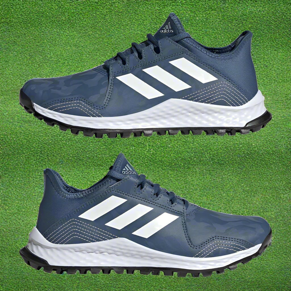 A pair of blue junior hockey shoes with white stripes, featuring a rubber outsole and synthetic upper material.