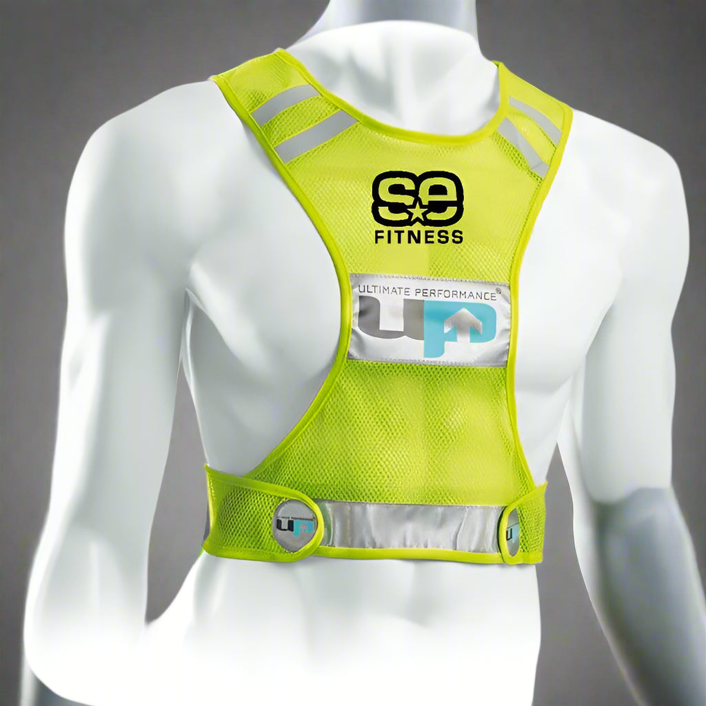 A yellow reflective race vest with the brand logo 'SE Fitness' and the word 'ULTIMATE PERFORMANCE' on the chest area. It has adjustable velcro tabs and is shown on a mannequin torso.