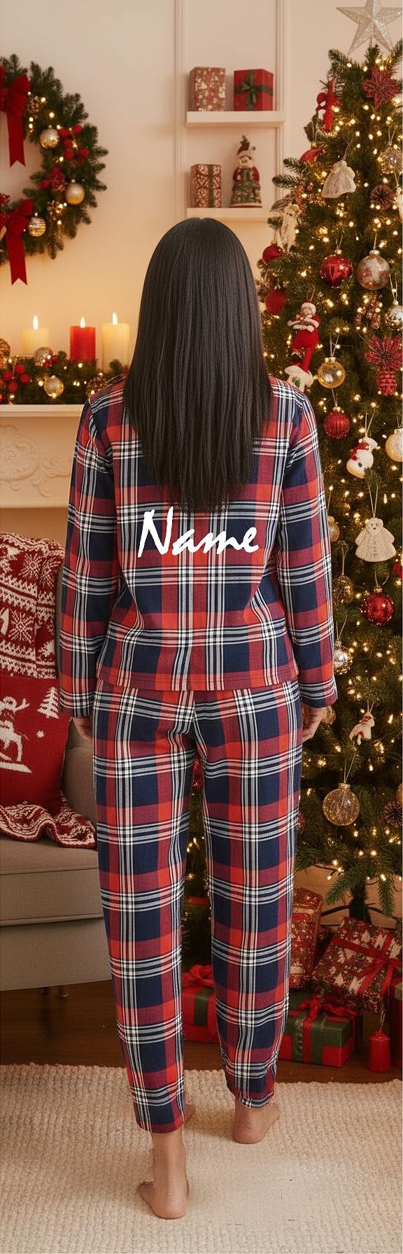 Person wearing plaid pajamas with 'Name' printed on the back, standing in a festive room with Christmas decorations.