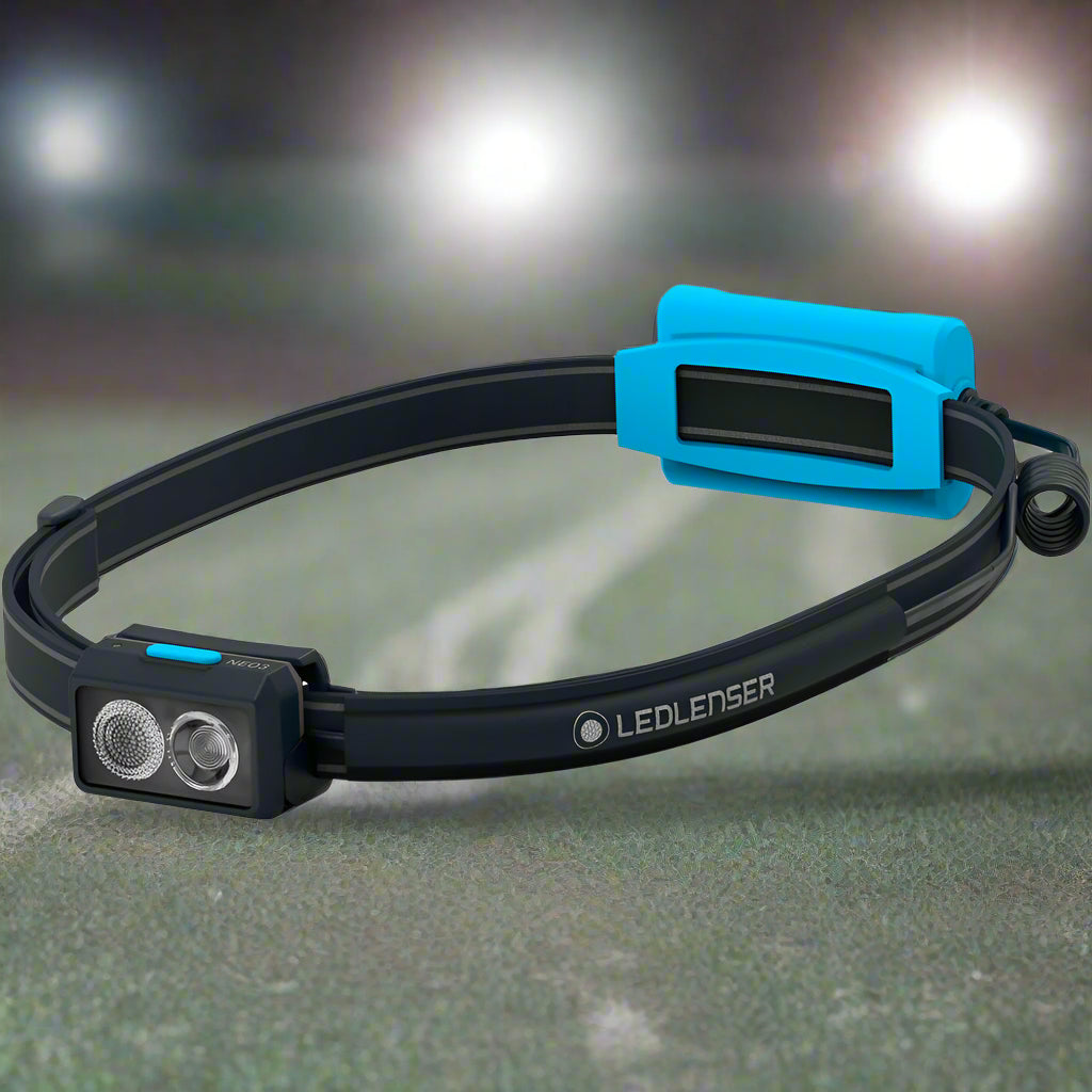 A black Led Lenser headlamp with a blue accent, featuring adjustable settings and two LED lights.