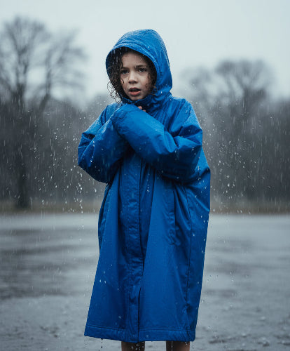 Person wearing a blue raincoat against a plain background