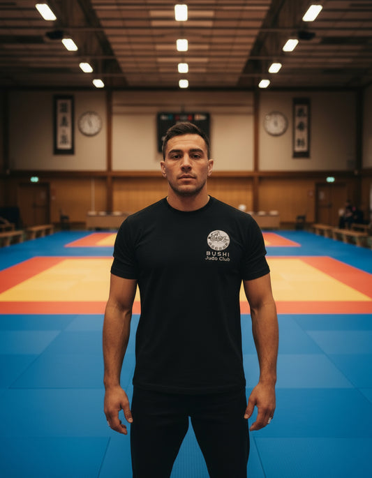 A black Bushi Judo T-shirt with the club's logo embroidered on the left chest.
