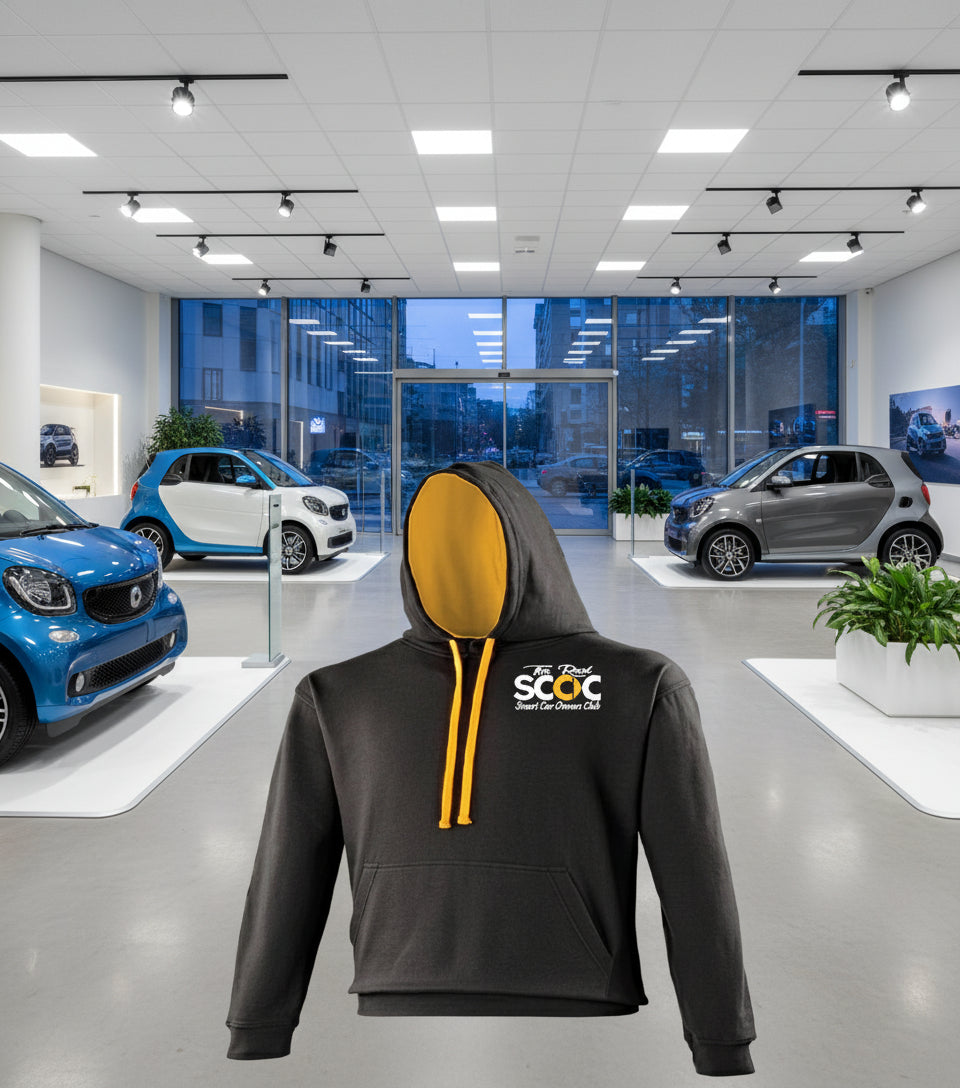 Black hoodie with yellow drawstrings and a logo on the chest against a white background