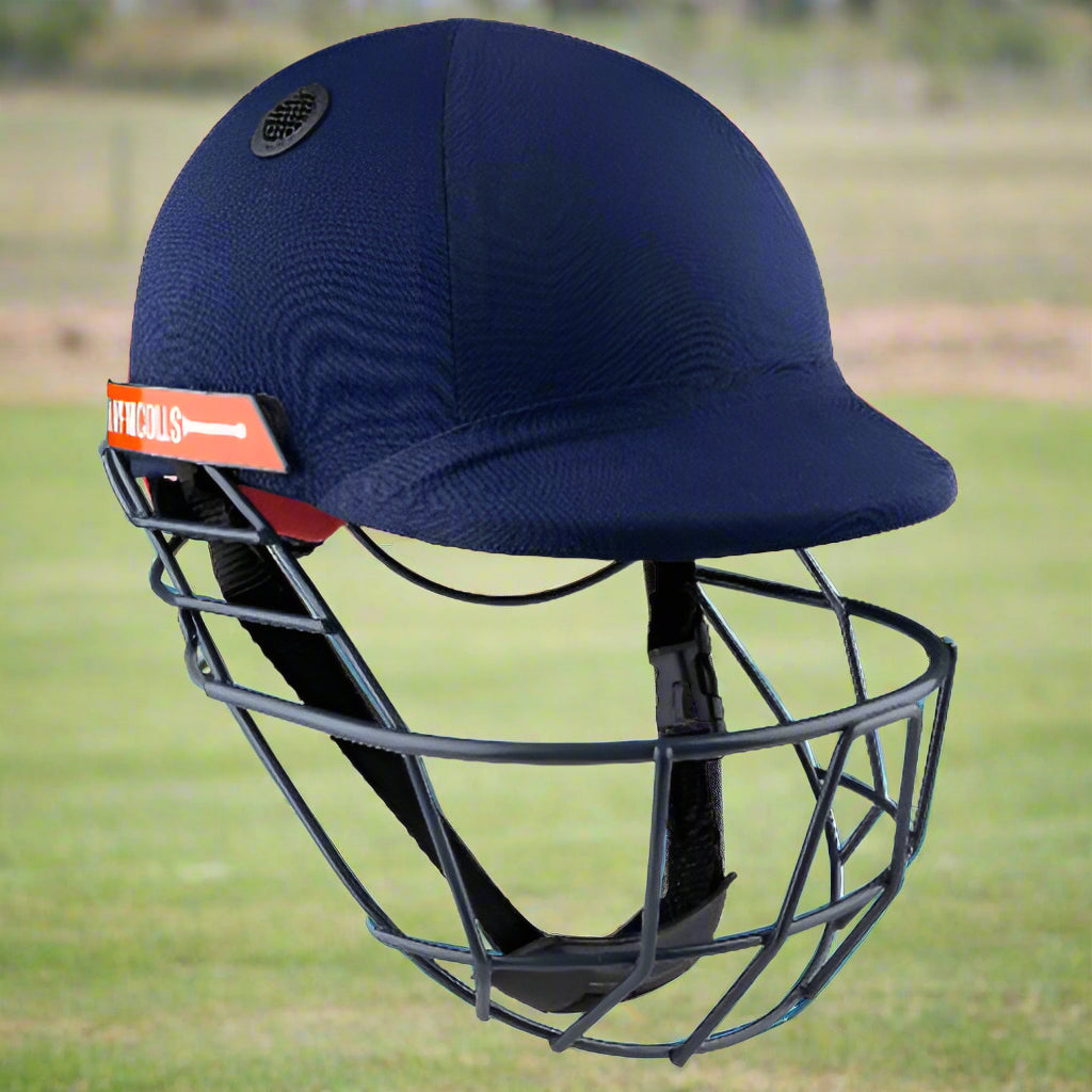 A navy blue Gray Nicolls Atomic cricket helmet with a faceguard and adjustable strap.