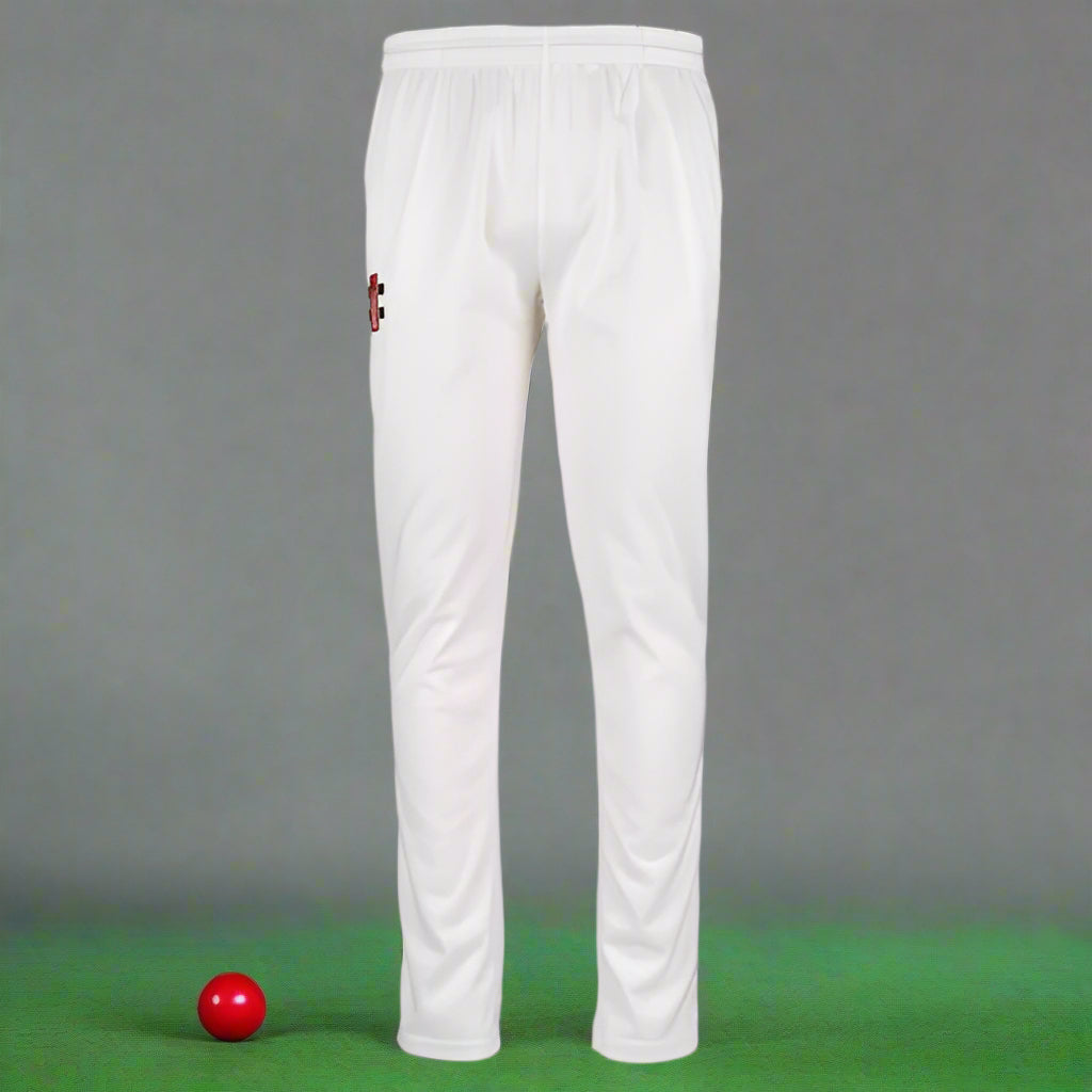 A pair of white cricket slim trousers with an elasticated waist and draw cord, featuring two pockets and a pre-finished hem.