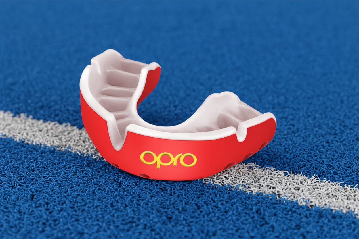 Red and white mouthguard with 'Opro' logo on a white background