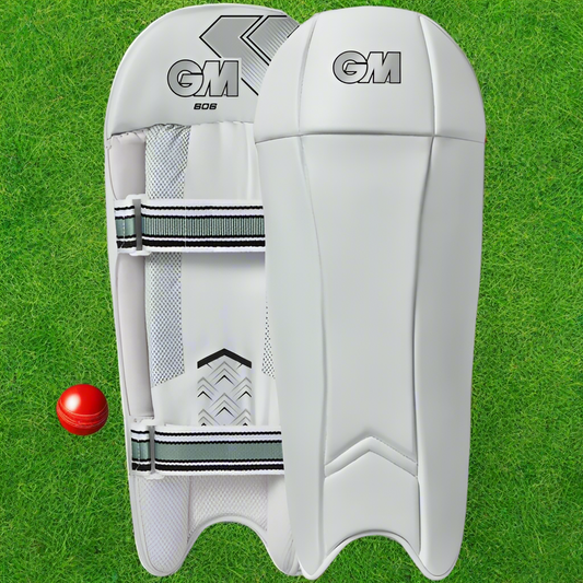 A pair of white Gunn and Moore cricket wicket keeping pads with green accents and straps.