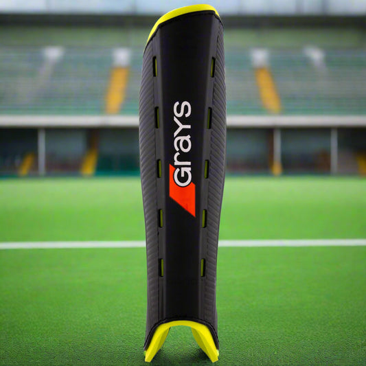 Black shin guard with yellow accents and 'Grays' branding on a white background