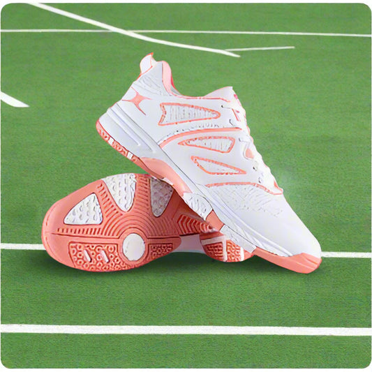 A pair of white and pink Volt netball shoes with a distinctive design, placed against a white background.
