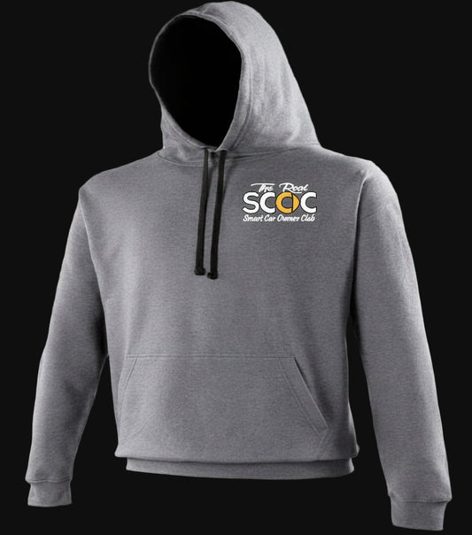 Gray hoodie with a logo on the back in a car showroom setting