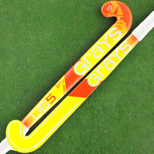 Yellow and orange hockey stick with 'Grays' branding on a white background