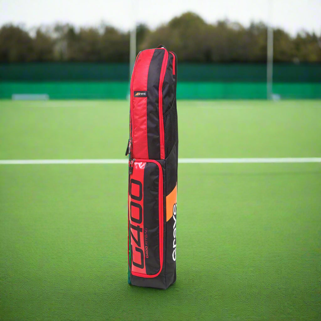 Red and black sports bag with branding on a white background