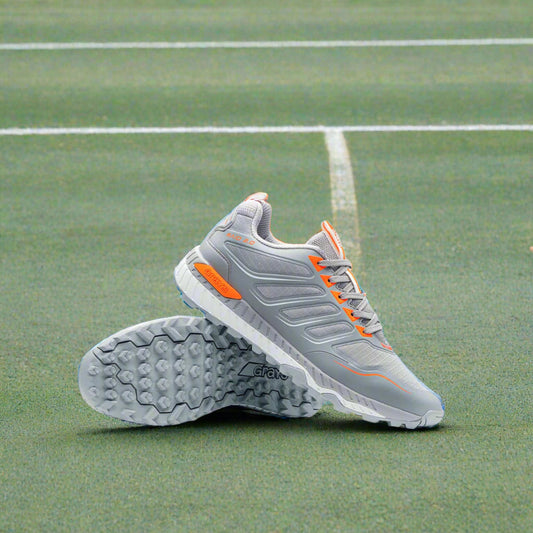 Gray HOCKEY shoes with orange accents on a light gray background
