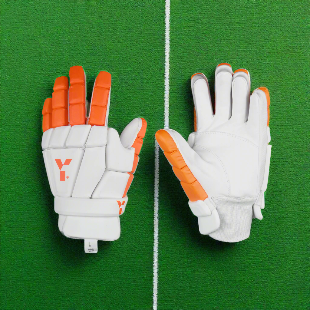 A pair of white and orange indoor flex hockey gloves with padding and a brand logo visible.