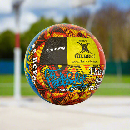 A Gilbert netball with a geometric pattern featuring the names 'Proscovia' and 'Peace' along with the Gilbert logo and the website 'www.gilbertnetball.