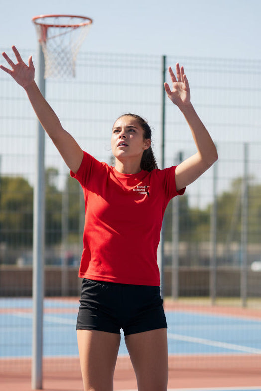 Red t-shirt with 'Elmdon Netball Club' logo on a white background