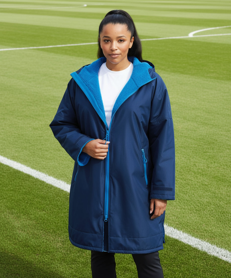 Two people wearing blue and black raincoats against a white background